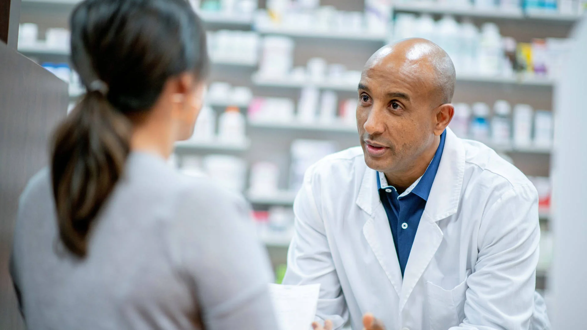 Pharmacist assisting a customer with healthcare products